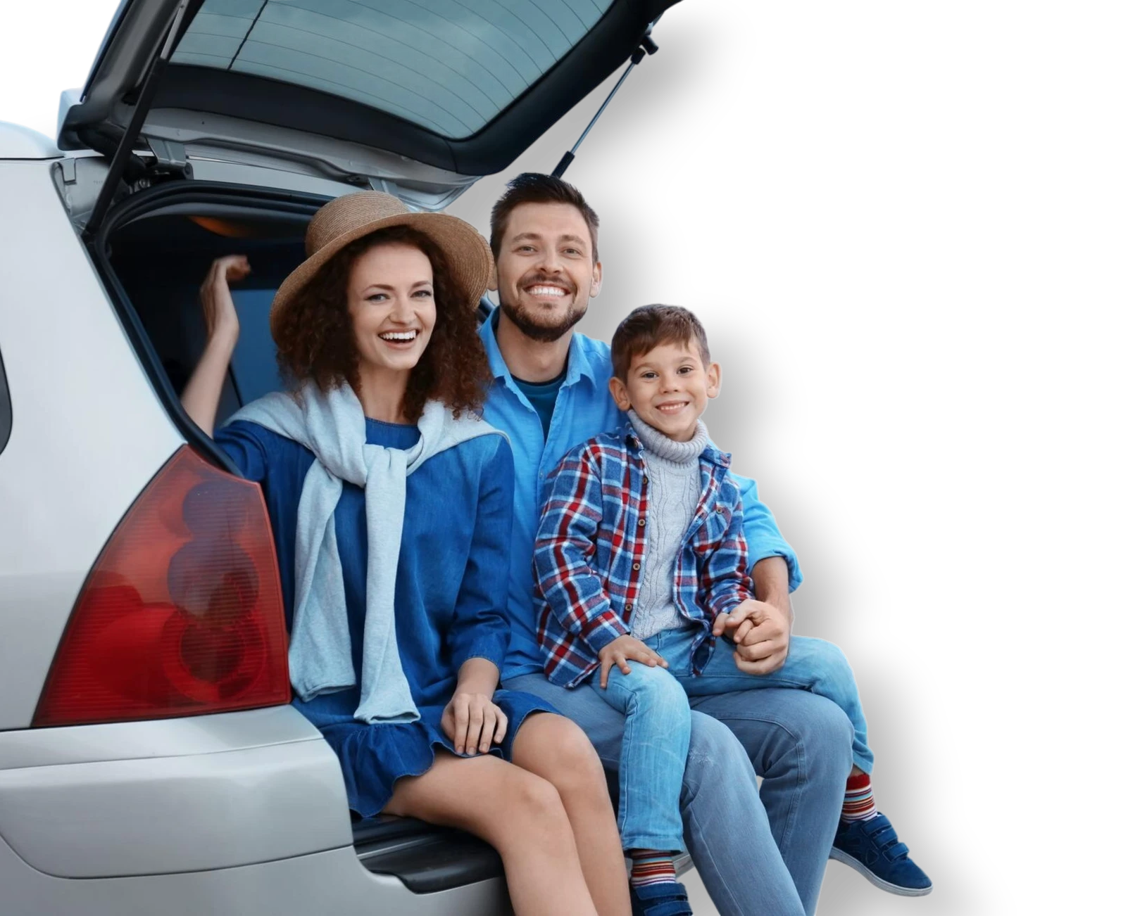 Family sitting in the open trunk of their car